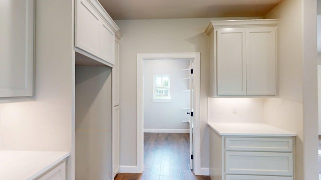 58 Lantana Ct, Lake Jackson, TX 77566 - kitchen featuring light countertops, wood finished floors, backsplash, and white cabinets