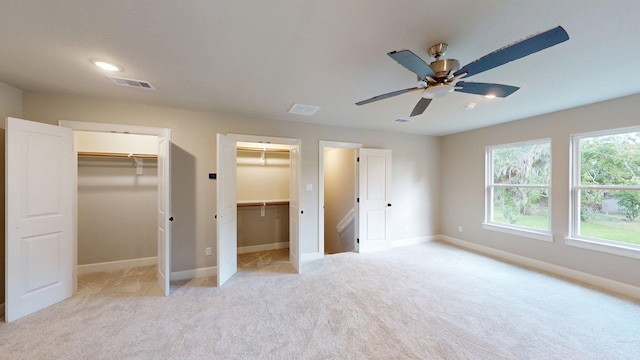 58 Lantana Ct, Lake Jackson, TX 77566 - unfurnished bedroom featuring light carpet, a ceiling fan, multiple closets, and a walk in closet