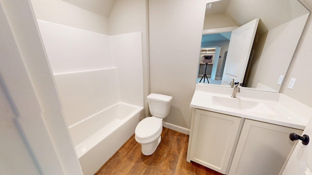 58 Lantana Ct, Lake Jackson, TX 77566 - bathroom featuring wood finished floors, vanity, shower / bathtub combination, and lofted ceiling