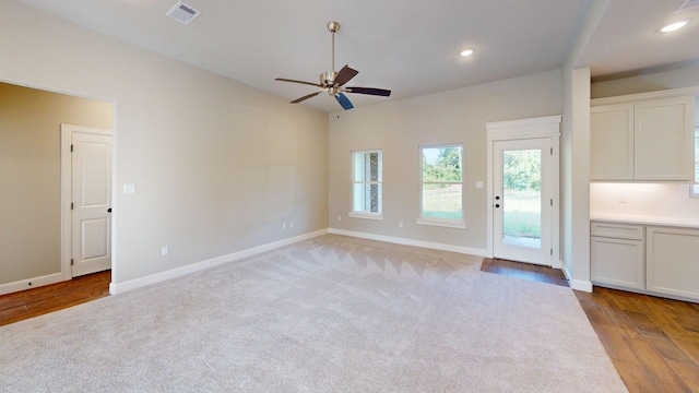 58 Lantana Ct, Lake Jackson, TX 77566 - unfurnished living room featuring ceiling fan, recessed lighting, light wood-style flooring, and light carpet