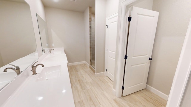 58 Lantana Ct, Lake Jackson, TX 77566 - bathroom with double vanity, wood finished floors, and a shower stall