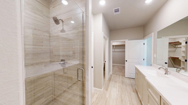 58 Lantana Ct, Lake Jackson, TX 77566 - full bathroom featuring a spacious closet, a stall shower, vanity, and recessed lighting