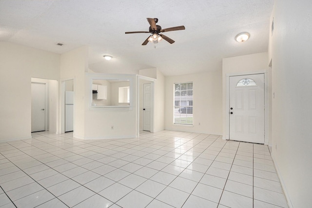 2612 Jeb Stuart Dr, League City, TX 77573 - unfurnished living room with a ceiling fan, light tile patterned flooring, and a textured ceiling