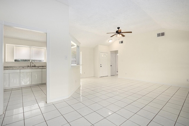 2612 Jeb Stuart Dr, League City, TX 77573 - spare room featuring vaulted ceiling, ceiling fan, light tile patterned flooring, and a textured ceiling