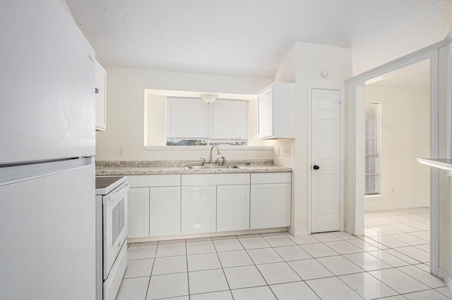 2612 Jeb Stuart Dr, League City, TX 77573 - kitchen featuring white appliances, white cabinetry, and light countertops