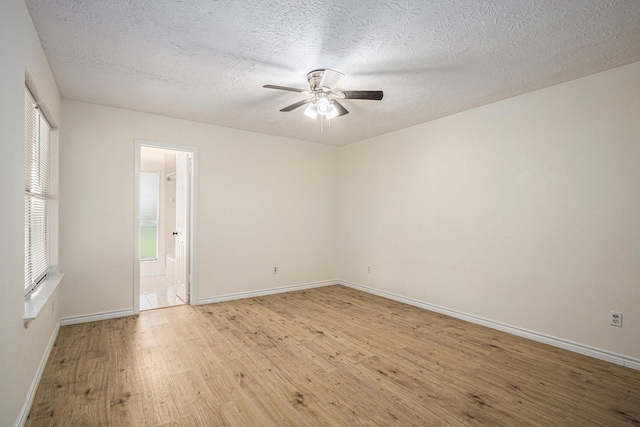 2612 Jeb Stuart Dr, League City, TX 77573 - empty room with light wood-style flooring, ceiling fan, and a textured ceiling