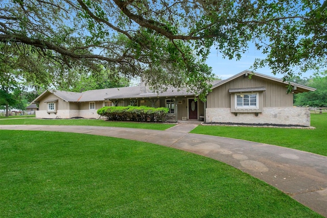 36602 Hondo Rd, Simonton, TX 77485 - ranch-style home featuring stone siding, a front lawn, and board and batten siding