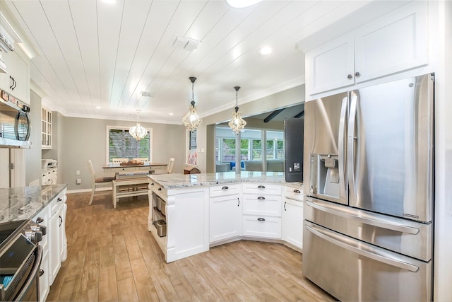 36602 Hondo Rd, Simonton, TX 77485 - kitchen with appliances with stainless steel finishes, a peninsula, white cabinets, a chandelier, and light wood-style floors