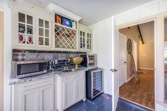 36602 Hondo Rd, Simonton, TX 77485 - bar featuring stainless steel microwave, wine cooler, and decorative backsplash
