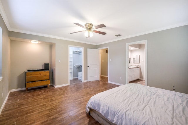 36602 Hondo Rd, Simonton, TX 77485 - bedroom with wood finished floors, ornamental molding, a walk in closet, ceiling fan, and connected bathroom