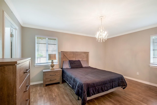 36602 Hondo Rd, Simonton, TX 77485 - bedroom with wood finished floors, a chandelier, and crown molding