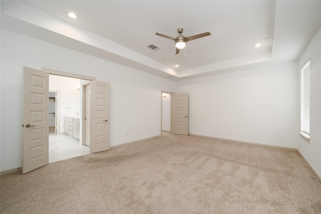 29423 Red Rocks Park Dr, Katy, TX 77494 - unfurnished bedroom with light carpet, recessed lighting, connected bathroom, a raised ceiling, and a ceiling fan