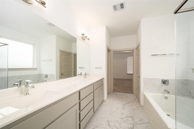 29423 Red Rocks Park Dr, Katy, TX 77494 - bathroom with marble look tiles, a bathtub, and double vanity