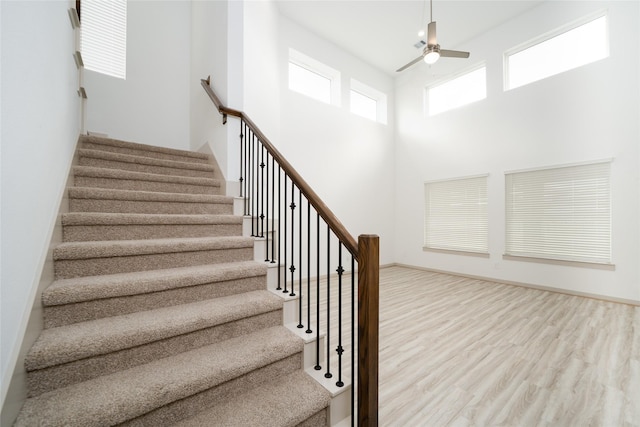 29423 Red Rocks Park Dr, Katy, TX 77494 - stairs with ceiling fan, wood finished floors, and a high ceiling
