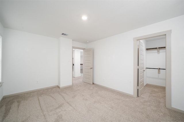 29423 Red Rocks Park Dr, Katy, TX 77494 - unfurnished bedroom featuring light carpet, a spacious closet, and recessed lighting