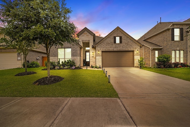 32927 Franklin Brooks Dr, Brookshire, TX 77423 - view of front of property featuring a garage, a yard, driveway, brick siding, and stone siding