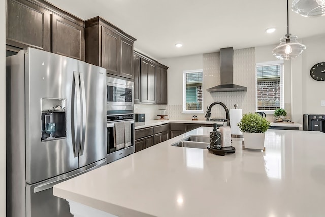 32927 Franklin Brooks Dr, Brookshire, TX 77423 - kitchen with stainless steel appliances, wall chimney exhaust hood, dark brown cabinetry, light countertops, and recessed lighting
