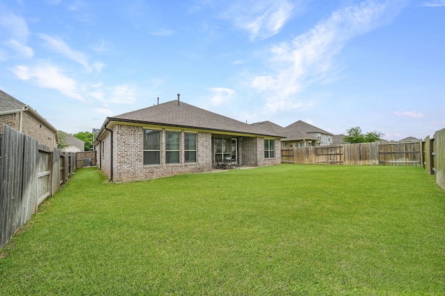 32927 Franklin Brooks Dr, Brookshire, TX 77423 - rear view of property featuring brick siding, a fenced backyard, and roof with shingles