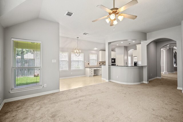 16115 Woodbend Trail Dr, Houston, TX 77070 - unfurnished living room featuring arched walkways, light colored carpet, ceiling fan, and lofted ceiling