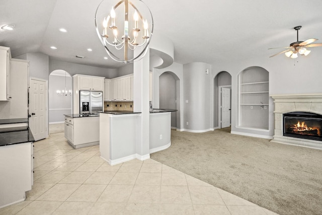 16115 Woodbend Trail Dr, Houston, TX 77070 - kitchen with stainless steel fridge with ice dispenser, open floor plan, arched walkways, a chandelier, and dark countertops