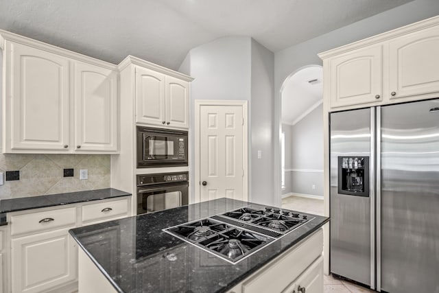 16115 Woodbend Trail Dr, Houston, TX 77070 - kitchen featuring black appliances, vaulted ceiling, arched walkways, dark stone countertops, and decorative backsplash