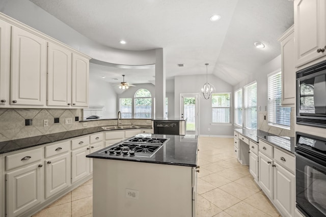 16115 Woodbend Trail Dr, Houston, TX 77070 - kitchen with black appliances, a kitchen island, vaulted ceiling, light tile patterned flooring, and ceiling fan