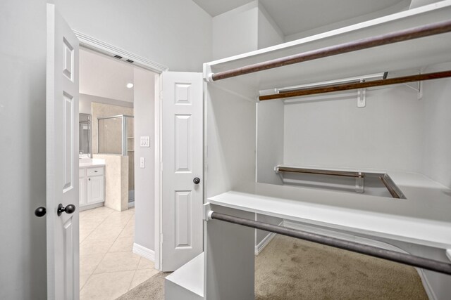 16115 Woodbend Trail Dr, Houston, TX 77070 - spacious closet featuring light tile patterned floors