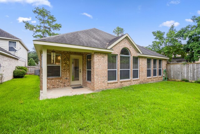 16115 Woodbend Trail Dr, Houston, TX 77070 - rear view of property featuring roof with shingles, brick siding, a fenced backyard, and a patio