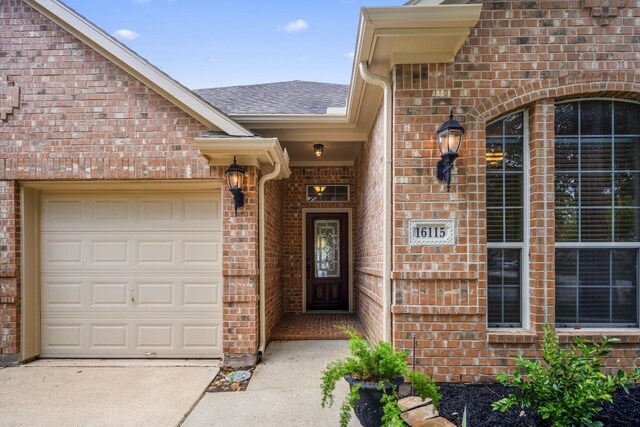 16115 Woodbend Trail Dr, Houston, TX 77070 - doorway to property with brick siding, driveway, a shingled roof, and a garage