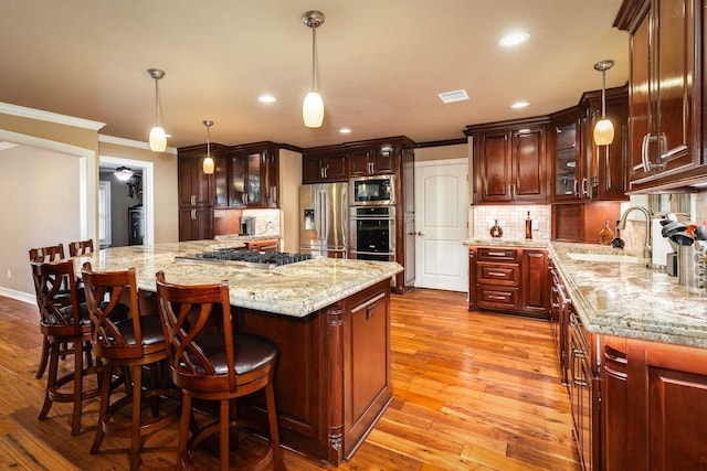 116 Cardinal St, Lake Jackson, TX 77566 - kitchen with appliances with stainless steel finishes, ornamental molding, decorative backsplash, recessed lighting, and decorative light fixtures