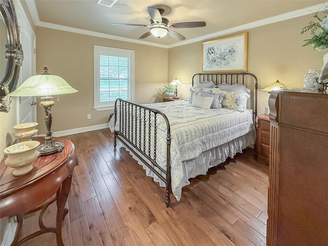 116 Cardinal St, Lake Jackson, TX 77566 - bedroom featuring wood finished floors, ornamental molding, and a ceiling fan