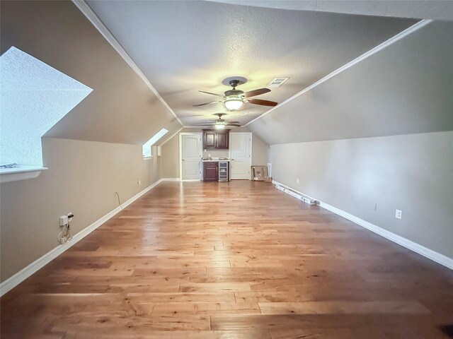 116 Cardinal St, Lake Jackson, TX 77566 - bonus room featuring ceiling fan, light wood finished floors, vaulted ceiling, and a textured ceiling