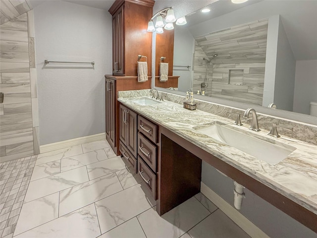 116 Cardinal St, Lake Jackson, TX 77566 - bathroom featuring marble look tiles, a tile shower, and double vanity