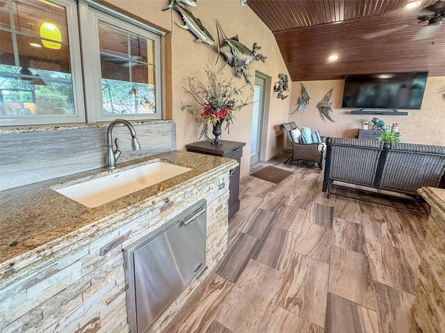 116 Cardinal St, Lake Jackson, TX 77566 - kitchen featuring wooden ceiling, light stone countertops, a textured wall, and wood finished floors