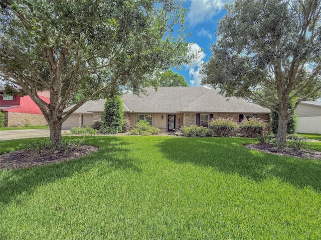 116 Cardinal St, Lake Jackson, TX 77566 - ranch-style house with a garage, a front lawn, concrete driveway, and a shingled roof