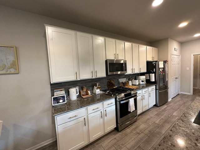 11711 Colossal Oak Dr, Houston, TX 77066 - kitchen with appliances with stainless steel finishes, decorative backsplash, recessed lighting, white cabinets, and dark wood-type flooring