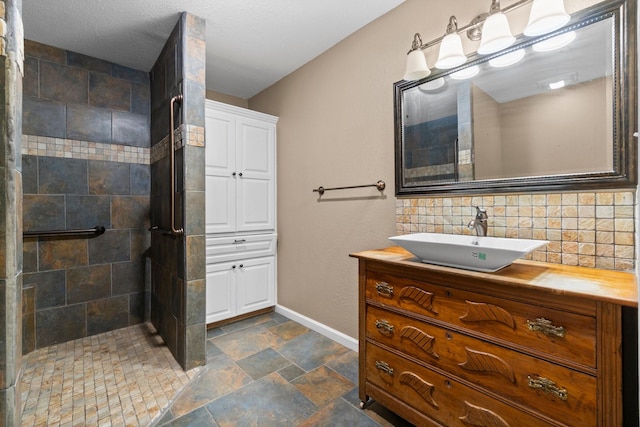 2540 Howell Rd, Corrigan, TX 75939 - full bath featuring vanity, a stall shower, stone tile floors, and tasteful backsplash