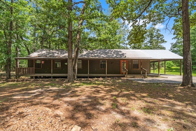 2540 Howell Rd, Corrigan, TX 75939 - view of front of home with covered porch, an attached carport, and concrete driveway