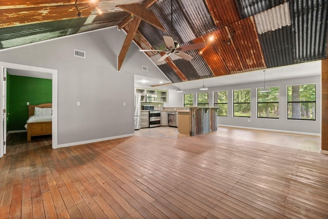 2540 Howell Rd, Corrigan, TX 75939 - unfurnished living room with high vaulted ceiling, light wood-type flooring, beam ceiling, and a ceiling fan