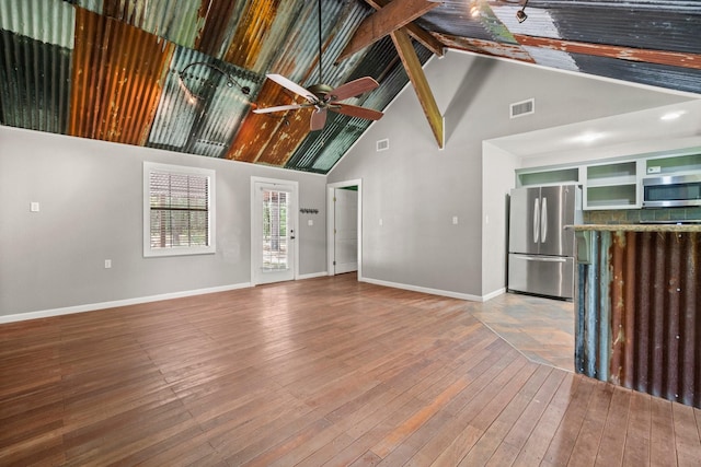 2540 Howell Rd, Corrigan, TX 75939 - unfurnished living room with high vaulted ceiling, a ceiling fan, hardwood / wood-style floors, and beam ceiling