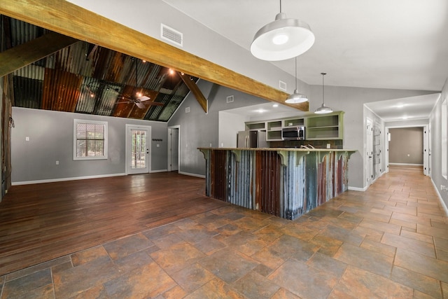 2540 Howell Rd, Corrigan, TX 75939 - kitchen with appliances with stainless steel finishes, high vaulted ceiling, stone tile flooring, open shelves, and decorative light fixtures