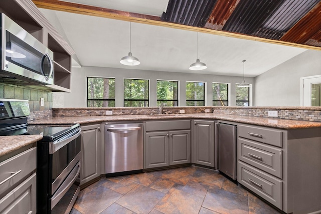 2540 Howell Rd, Corrigan, TX 75939 - kitchen with stainless steel appliances, gray cabinets, open shelves, dark stone finish floors, and vaulted ceiling