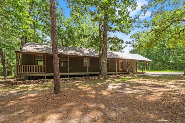 2540 Howell Rd, Corrigan, TX 75939 - view of front of home with a metal roof and an attached carport