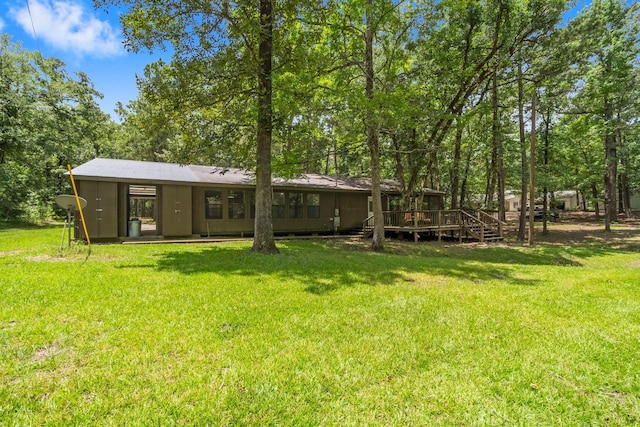 2540 Howell Rd, Corrigan, TX 75939 - rear view of house with a lawn and a wooden deck
