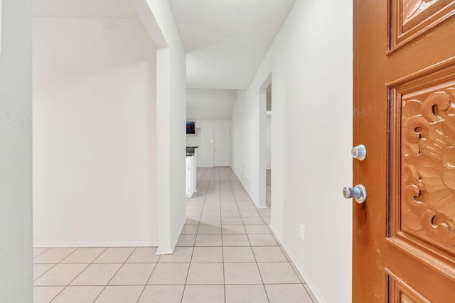 9403 Pinole Ln, Houston, TX 77086 - corridor featuring light tile patterned flooring and baseboards