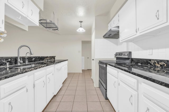 9403 Pinole Ln, Houston, TX 77086 - kitchen with stainless steel range with electric cooktop, exhaust hood, white cabinetry, light tile patterned floors, and decorative backsplash