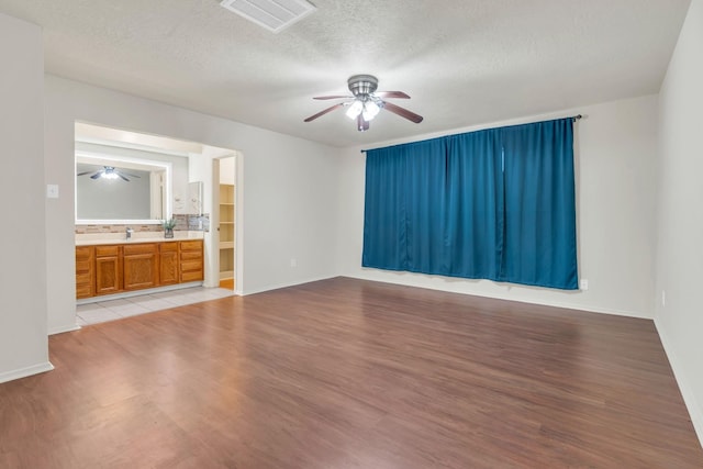 9403 Pinole Ln, Houston, TX 77086 - spare room with a ceiling fan, light wood-style flooring, and a textured ceiling
