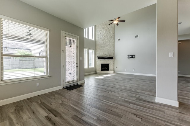 10318 Easterly Ln, Cypress, TX 77433 - unfurnished living room featuring a ceiling fan, high vaulted ceiling, wood finished floors, and plenty of natural light