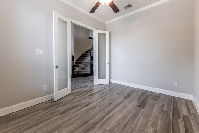 10318 Easterly Ln, Cypress, TX 77433 - unfurnished room with ceiling fan, wood finished floors, crown molding, stairs, and french doors