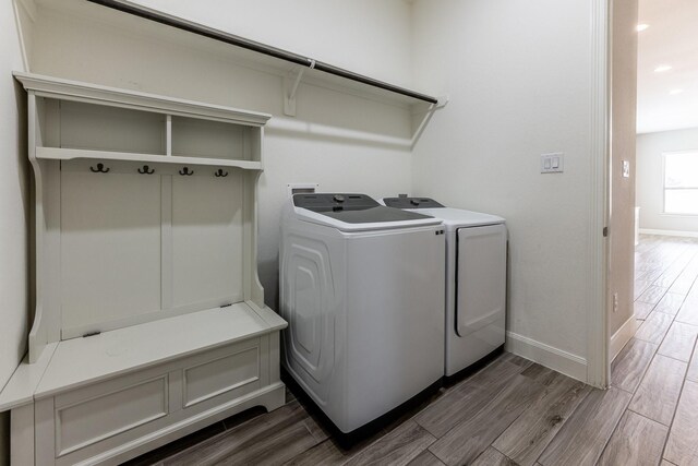 10318 Easterly Ln, Cypress, TX 77433 - laundry area featuring washer and dryer, wood finished floors, and recessed lighting